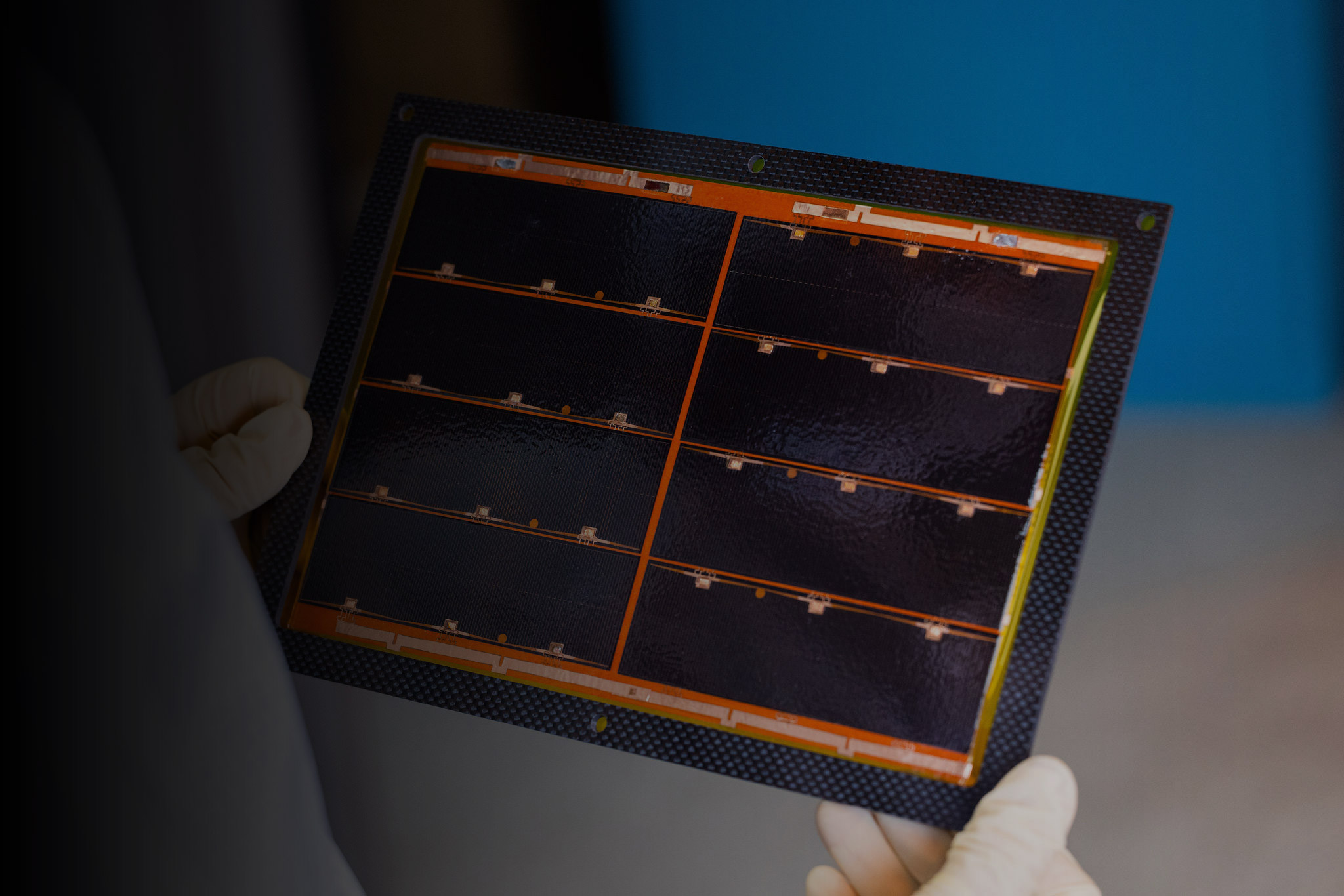 Lab technician holding an Integrated Solar Panel Module