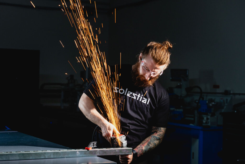 a person using an angle grinder on a piece of metal creating sparks